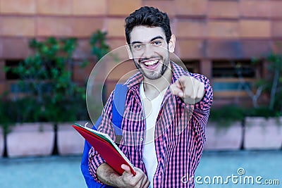 Happy spanish male student walking to university Stock Photo