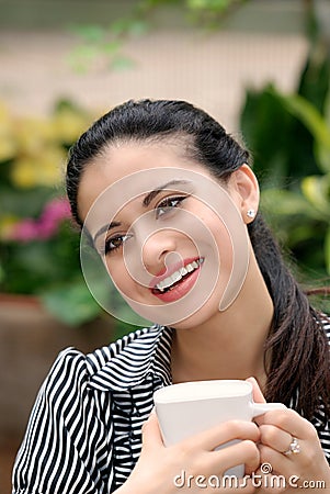 Happy spanish woman drinking coffee Stock Photo
