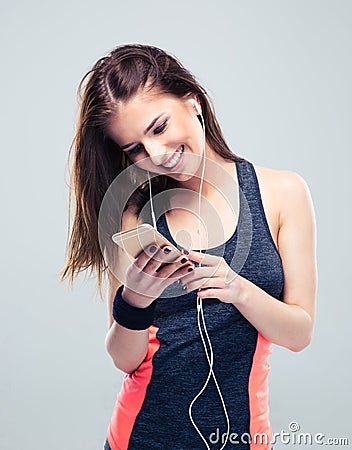 Happy sports woman using smartphone Stock Photo