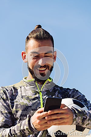 Happy sportsman laughing looking his cell phone Stock Photo