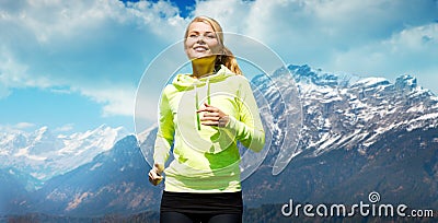 Happy sporty woman running or jogging outdoors Stock Photo