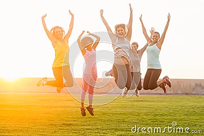 Happy sporty women jumping during fitness class Stock Photo