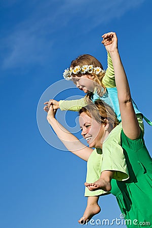 Happy spring girls against blue sky Stock Photo