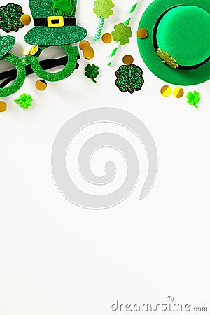 Happy St Patrick`s Day vertical banner template. Frame top border made of party eyeglasses, leprechauns hat, shamrock clover, Stock Photo