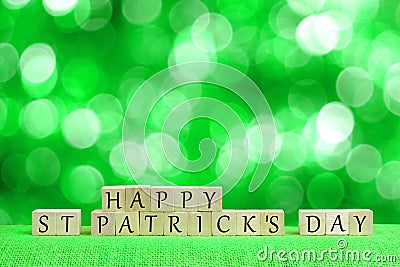 Happy St Patricks Day blocks with twinkling green background Stock Photo