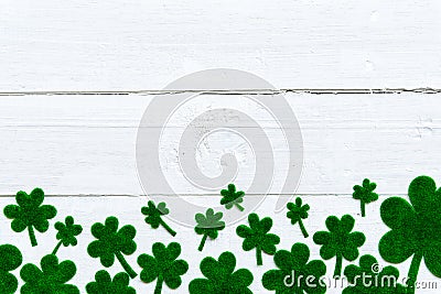 Green paper clover leaf on white wooden background Stock Photo