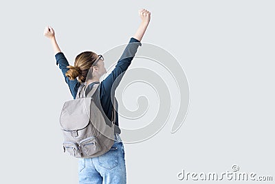 Happy student with arms raised on air Stock Photo
