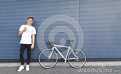 Happy student with a bike looking into the camera Stock Photo