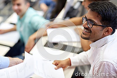 Happy student with exam test or handout at lecture Stock Photo