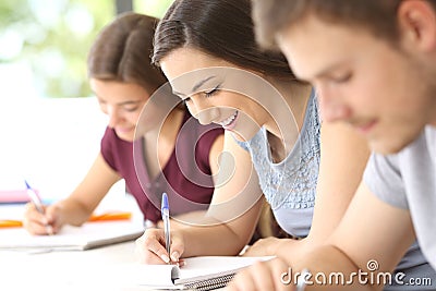 Happy student taking notes in classroom Stock Photo