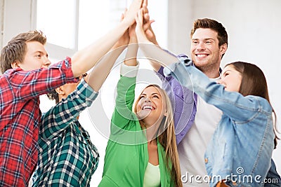 Happy students giving high five at school Stock Photo