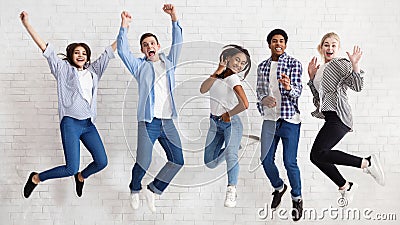 Happy students jumping on white background, passed exams Stock Photo