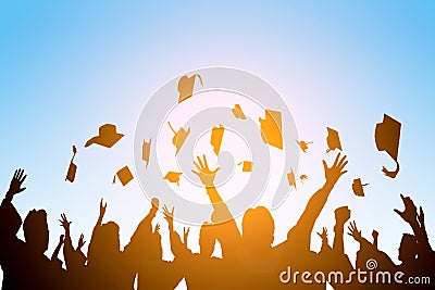 Happy students throwing graduation caps in the Air Stock Photo
