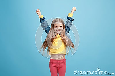Happy success teen girl celebrating being a winner. Dynamic energetic image of female model Stock Photo