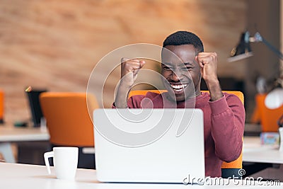 Happy successful African American businessman in a modern startup office indoors Stock Photo