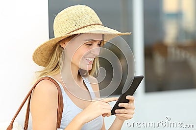 Happy summer tourist checking smart phone Stock Photo