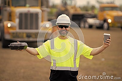 happy supervisor at the construction. supervisor man at construction site. worker at lunch break. male supervisor at Stock Photo