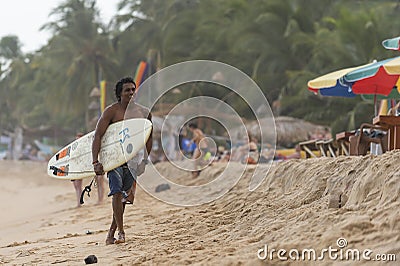 Happy surfer walking on the beach Editorial Stock Photo