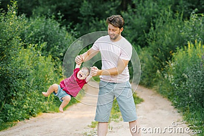 Happy and sweet moments of a summer walk in the park of a father and a little son Stock Photo