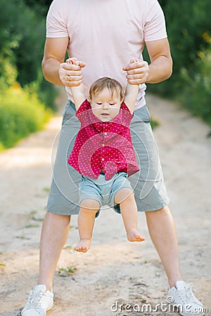 Happy and sweet moments of a summer walk in the park of a father and a little son Stock Photo