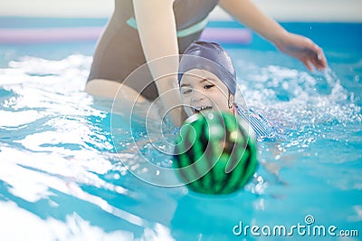 Happy swimming with ball kid Stock Photo