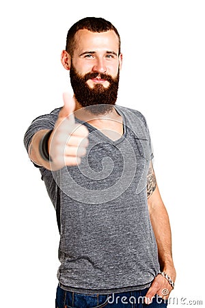 Happy Tattooed bearded man with thumbs up gesture Stock Photo