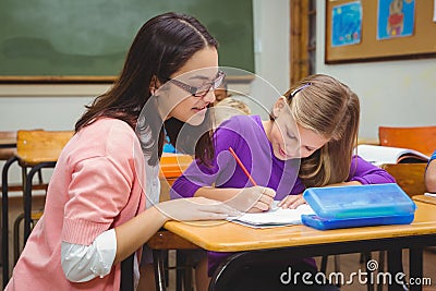 Happy teacher helping her students Stock Photo