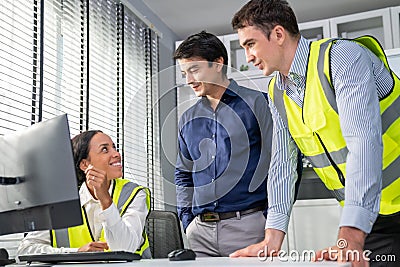 Happy team of competent engineers and investor smile and work together. Stock Photo