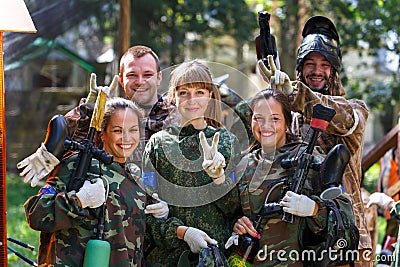 Happy team of five paintball players outdoors Stock Photo