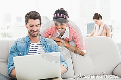 Happy teamwork working together with laptop Stock Photo