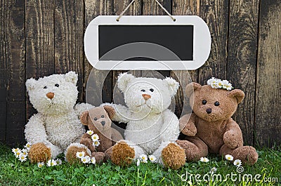 Happy teddy bear team on wooden background for a greeting card w Stock Photo