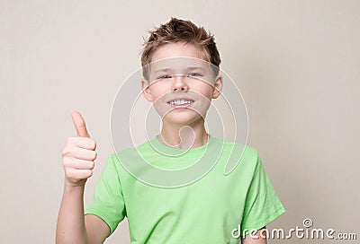 Happy teen boy with removable dental brace showing thumb up gesture Stock Photo