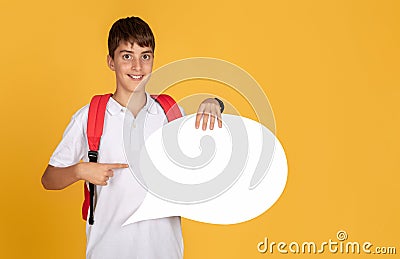 Happy teen european schoolboy with backpack points finger at abstract cloud for words and thoughts Stock Photo