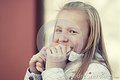 Happy teen girl eating a burger Stock Photo