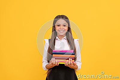 happy teen girl in school uniform hold book stack, reading Stock Photo