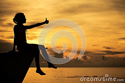 Happy teen girl sitting on beach Stock Photo