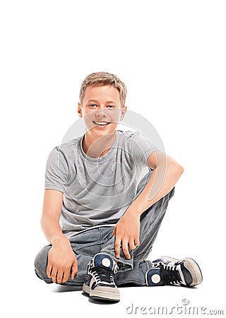 Happy teenage boy sitting on the floor Stock Photo