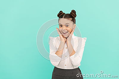 Happy teenage girl back to school touching face skin blue background, skincare Stock Photo