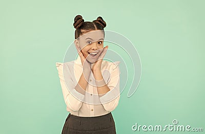 Happy teenage girl back to school touching face skin blue background, skincare Stock Photo