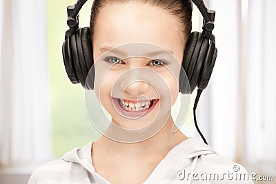 Happy teenage girl in big headphones Stock Photo