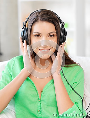 Happy teenage girl in big headphones Stock Photo