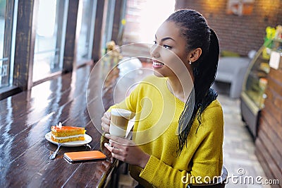 Happy teenage girl enjoying her coffee break Stock Photo