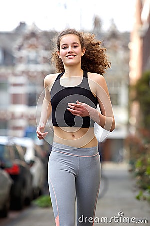Happy teenage girl running outside Stock Photo