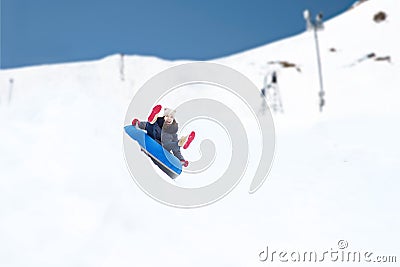 Happy teenage girl sliding down on snow tube Stock Photo