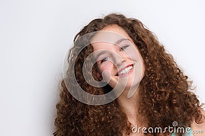 Happy teenage girl smiling with curly hair Stock Photo