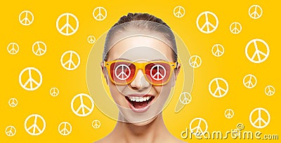 Happy teenage hippy girl in shades with peace sign Stock Photo