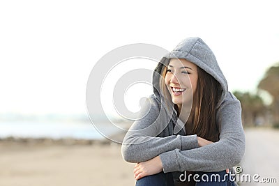 Happy teenager girl looking at side outdoors Stock Photo