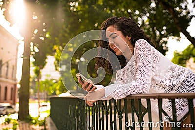 Happy teenager looking at the cellphone Stock Photo