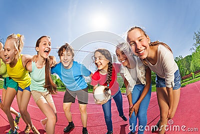 Happy teens standing on the volleyball game court Stock Photo