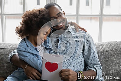 Happy thankful african ethnicity daddy caring little biracial daughter. Stock Photo
